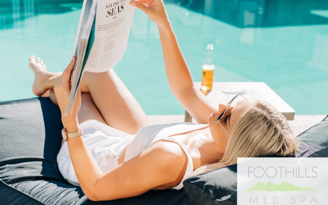 A woman lounging by the pool, reading a magazine
